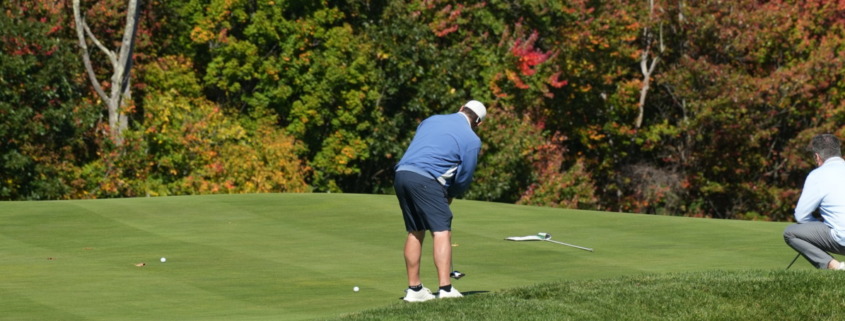 A golfer attempts a tricky putt